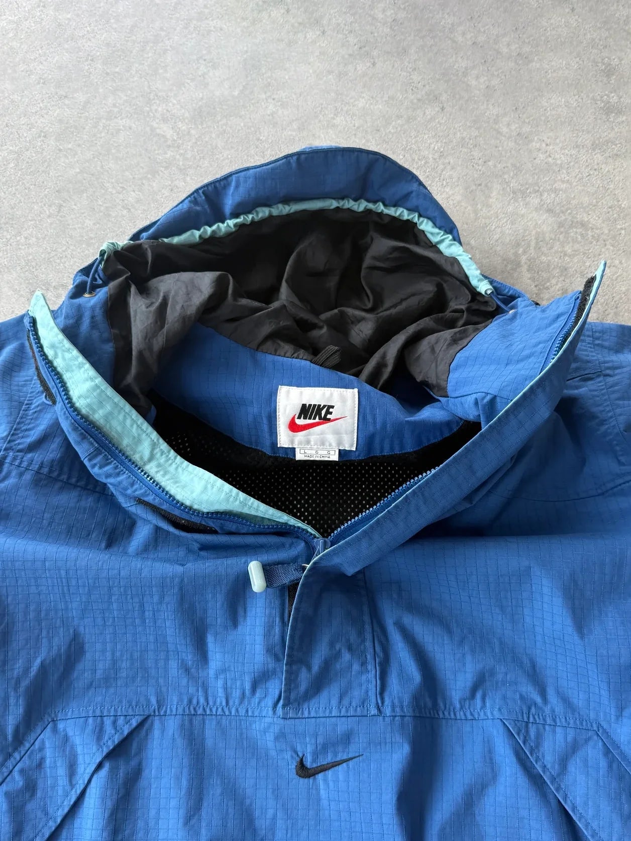 nike acg 1990s lightweight technical ripstop anorak in blue, back view
