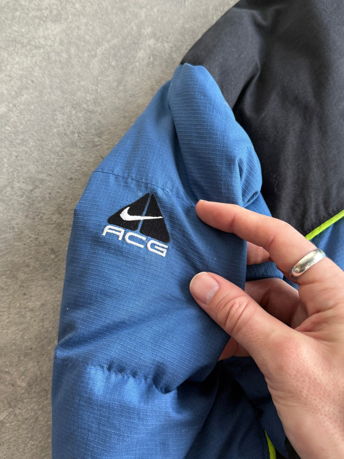 nike acg 1998 technical down fill puffer jacket in blue and black, side view