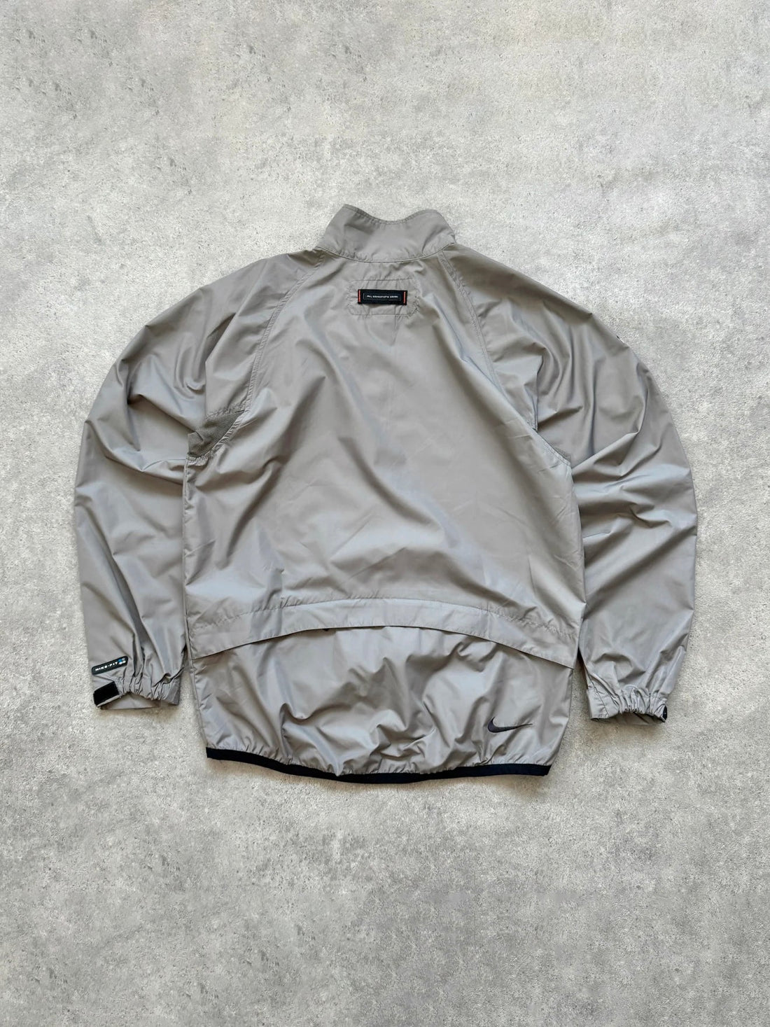 nike acg 1990s packable shell jacket in grey, back view