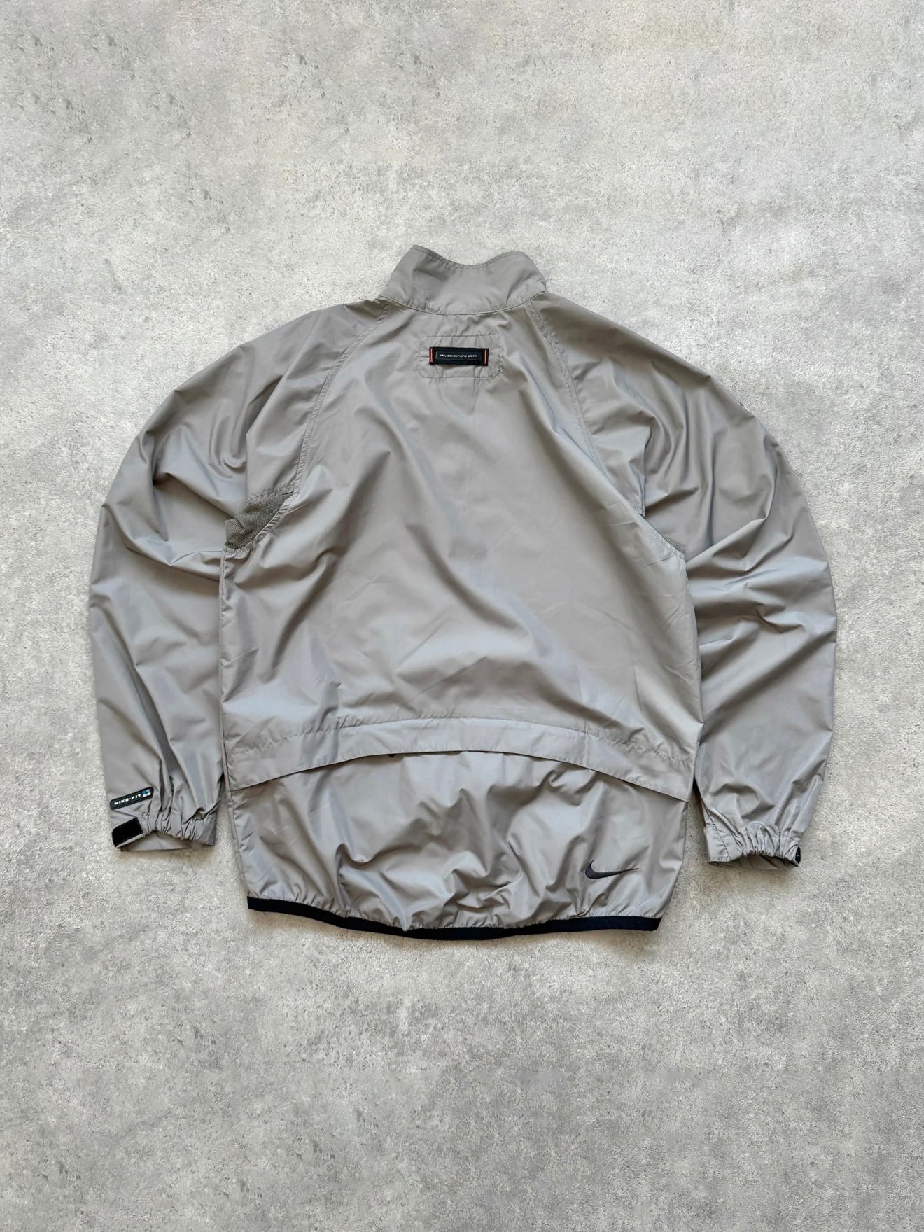 nike acg 1990s packable shell jacket in grey, back view
