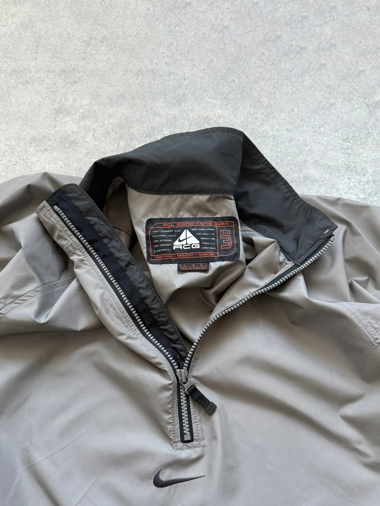 nike acg 1990s packable shell jacket in grey, side view