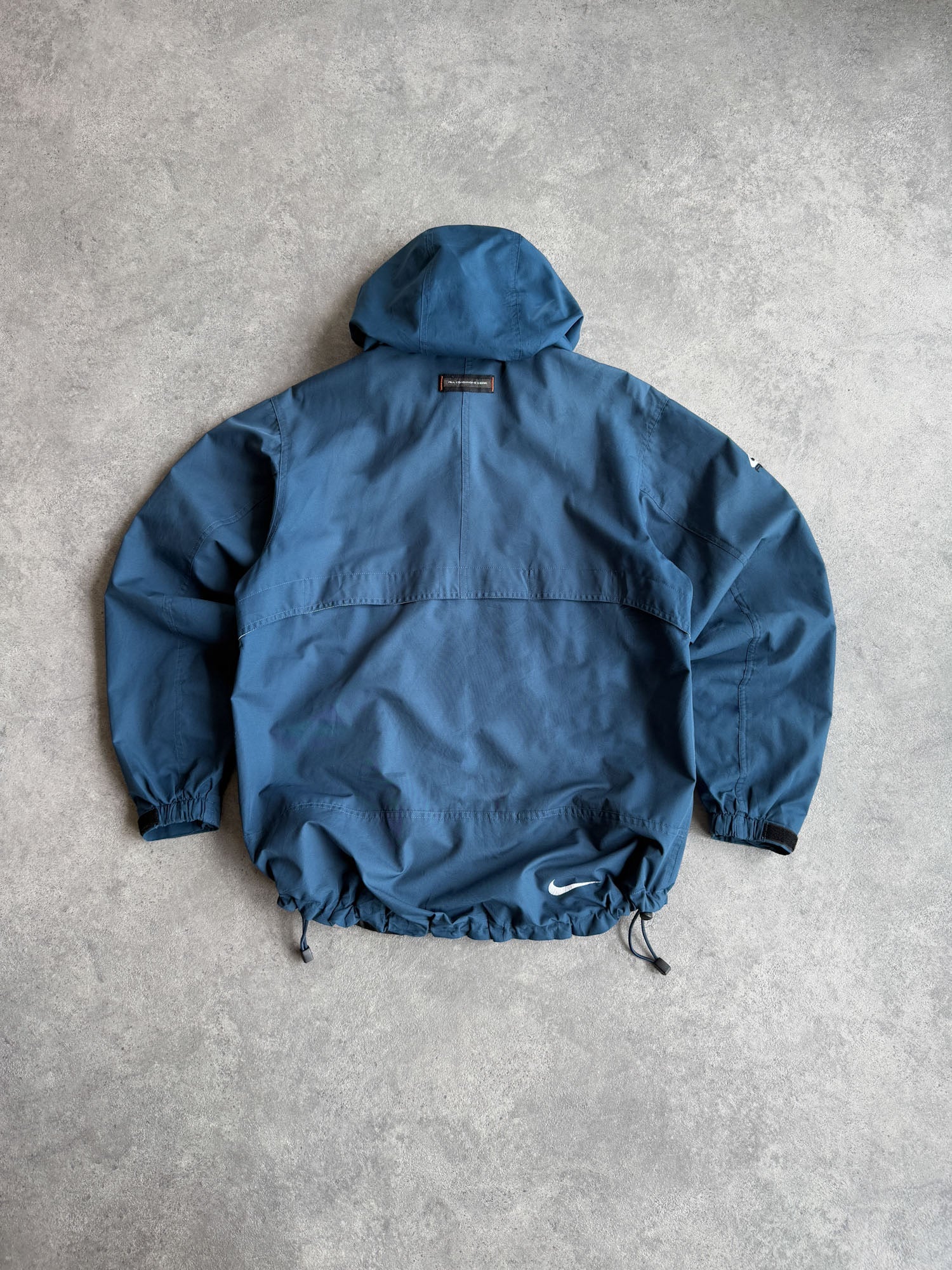nike acg 1990s lightweight technical waterproof jacket in blue, back view