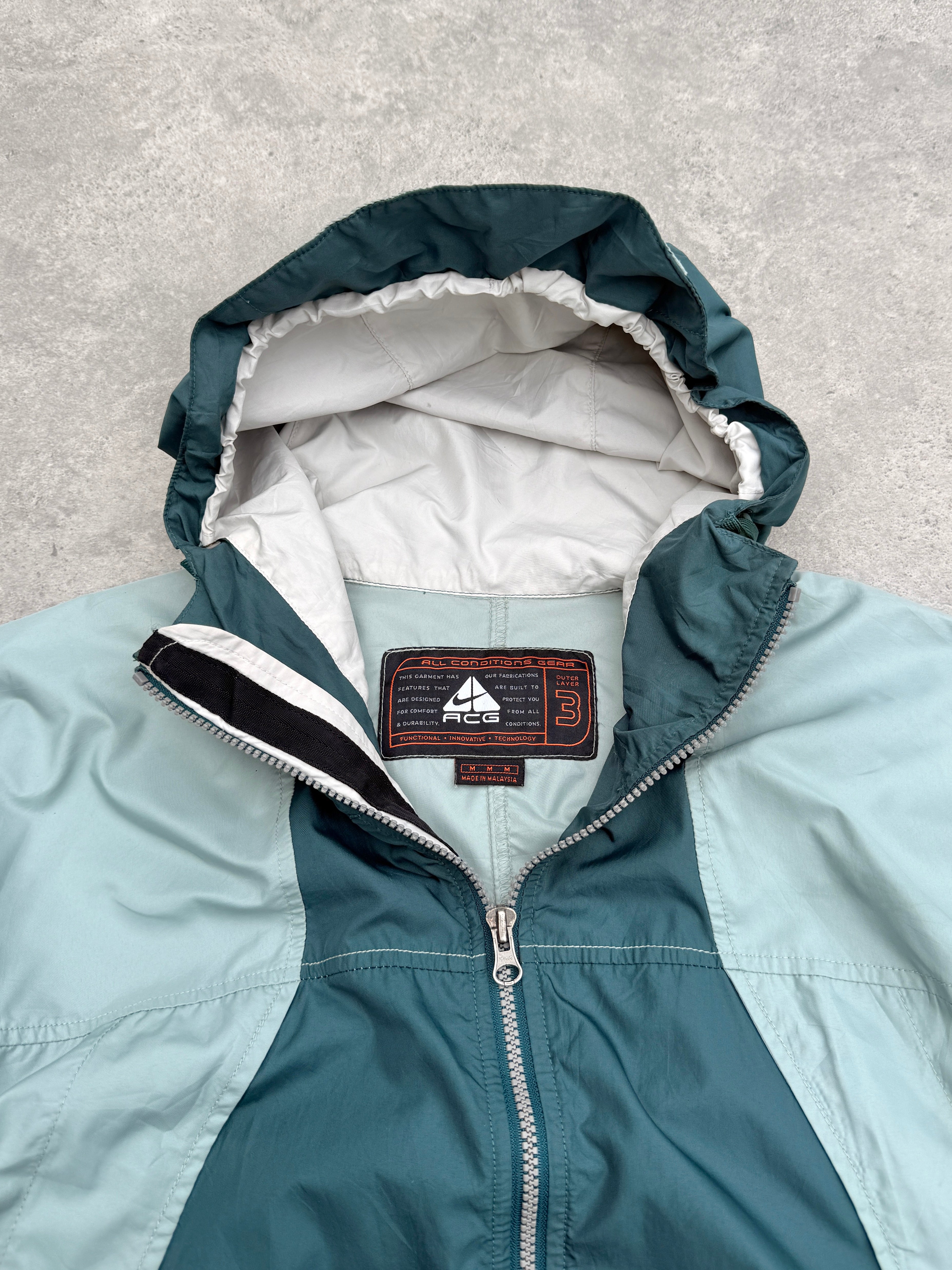 nike acg 1990s colour block packable jacket in teal ice-blue, back view