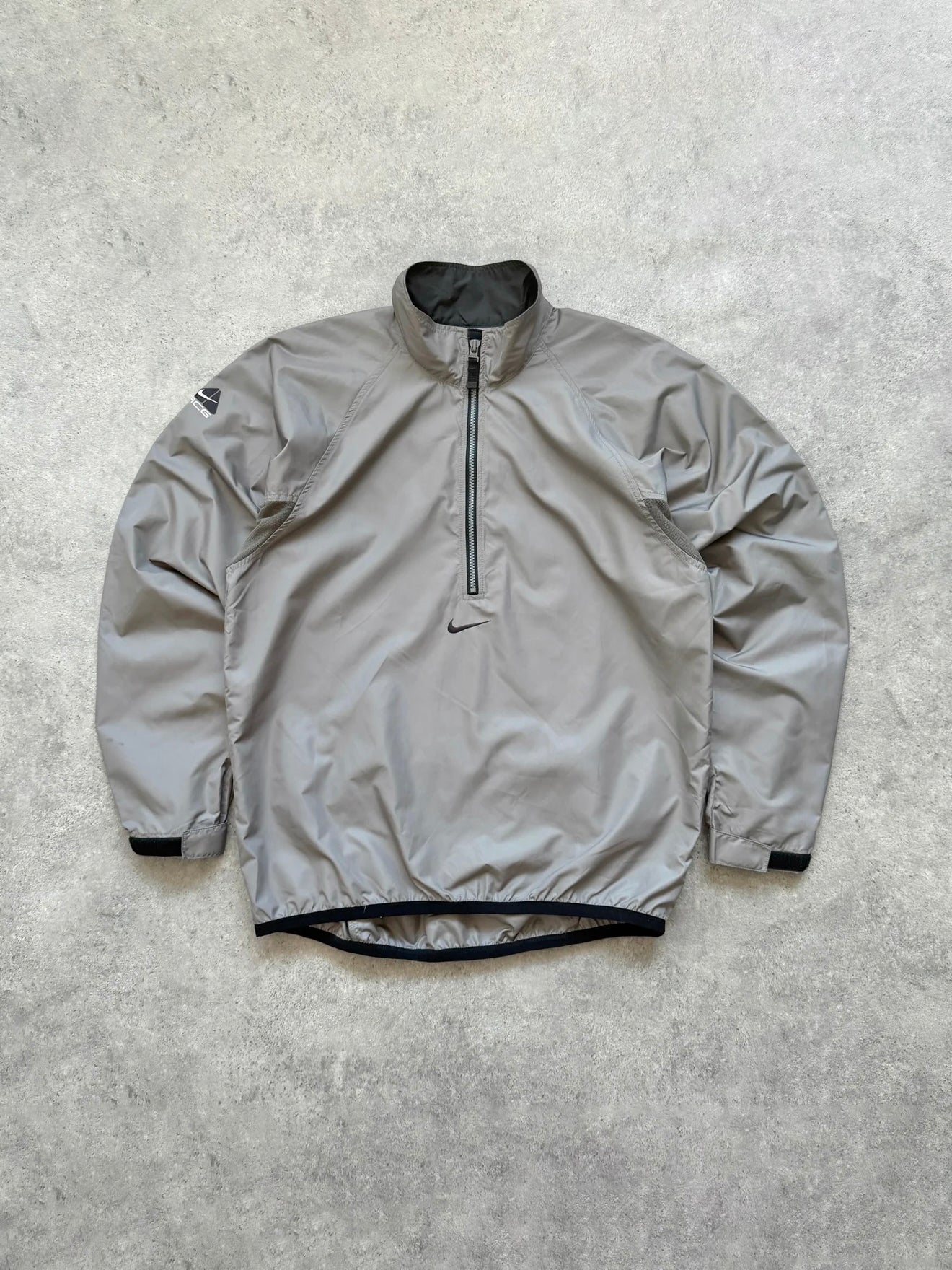 nike acg 1990s packable shell jacket in grey, front view