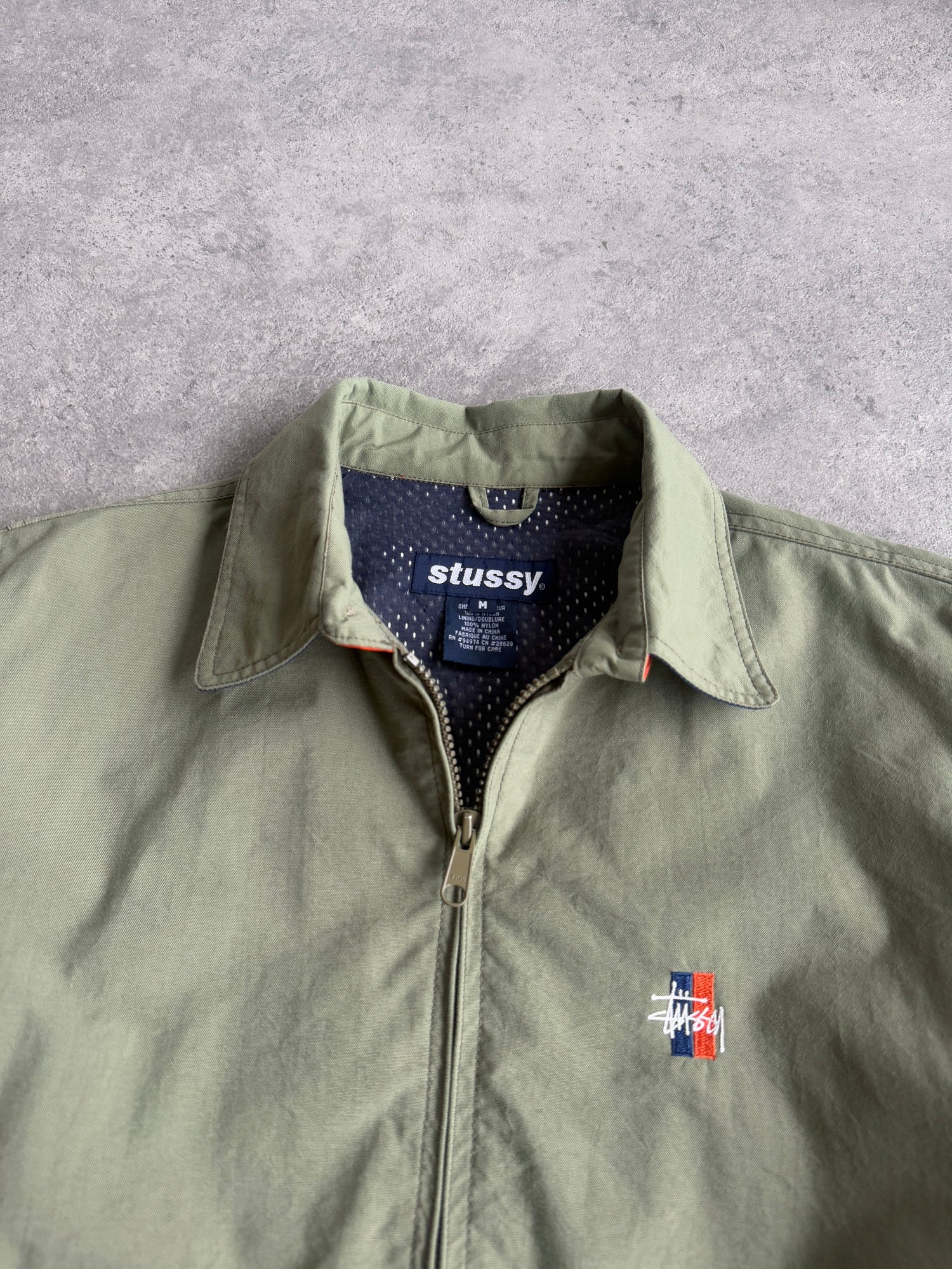 stussy 1990s lightweight nylon harrington jacket in olive, back view